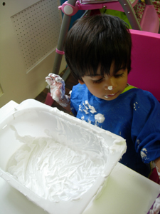 Girl playing with foam at Early Learners' Nursery School, Leicester